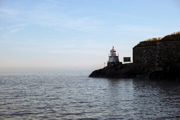 Fototapeta na wymiar Lighthouse by the sea on a calm day