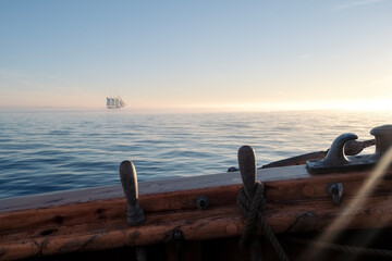 Sailboat on the horizon at sunset