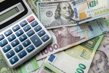 Fototapeta premium euro, dollars, hryvnia currency with calculator. Financial background