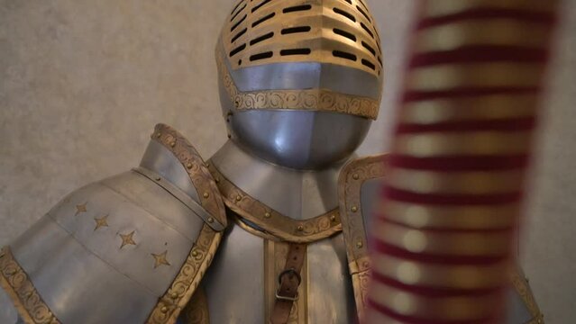 Close up historic ancient metal suit of armour on display in museum