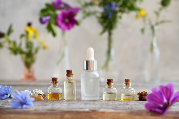 Selection of essential oils with frankincense, flowers and herbs