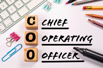 COO - Chief Operating Officer. Computer keyboard and office supplies on a white background