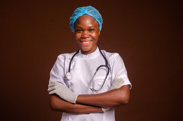 African american nurse girl wearing medical uniform and stethoscope over brown background excited for success