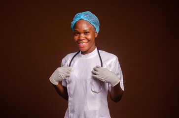 African american nurse girl wearing medical uniform and stethoscope over brown background excited for success