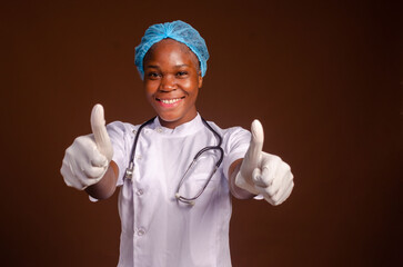 African american female doctor wear white medical coat stethoscope showing thumb up.