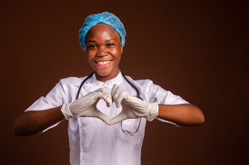 young african nigerian woman preventing, prevent, prevented herself from the outbreak in his society and did a love sign.