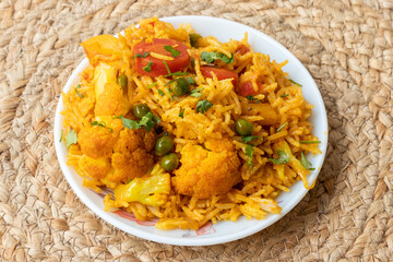 Vegetable pulao recipe made with basmati rice and mix vegetables served in a round plate