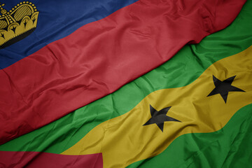 waving colorful flag of sao tome and principe and national flag of liechtenstein.
