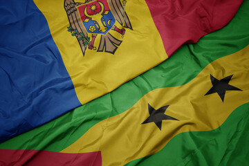 waving colorful flag of sao tome and principe and national flag of moldova.