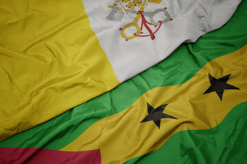 waving colorful flag of sao tome and principe and national flag of vatican city.