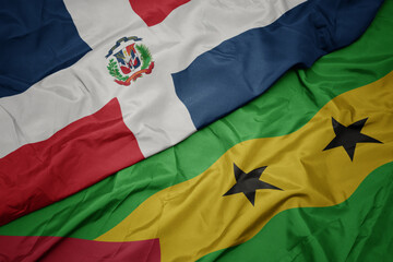 waving colorful flag of sao tome and principe and national flag of dominican republic.