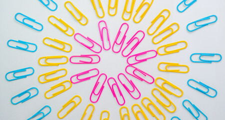 Paper clips, Paper clips in pink yellow and blue color lay in circle with white background, Office and school supplies concepts, Equipment concept.