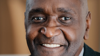 Closeup male portrait headshot face with wrinkles African American adult 60s old senior mature...