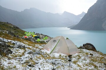Colorful tents on bank of Lake Ala-Köl (Ala-kol, Ala-kul) in Tien Shan mountains in west of...