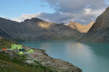 Colorful tents on bank of Lake Ala-Köl (Ala-kol, Ala-kul) in Tien Shan mountains in west of...