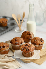 Banana chocolate chip muffin on wood and bottle milk on white background