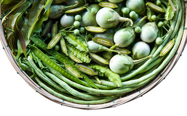 Top view of vegetables with plenty of traditional herbal paste spread together in a bamboo basket.