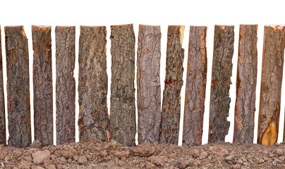 Isolates of fence poles made from tree bark slot is located on the ground floor, simple insecurity.