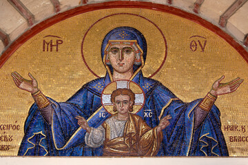 Colourful mosaic hagiography of Mother of God ,on the facade above the entrance of the church of Panagia Giatrissa in Loutraki, Greece