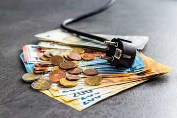 Electric plug and euro money. Concept of increasing electricity prices.