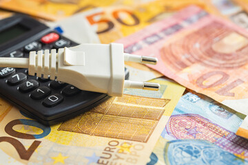 Electric plug, calculator and euro money. Concept of increasing electricity prices.