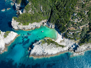 Aerial view of the secluded Spilia Beach at the rough and cliffy east coast of Skopelos island,...