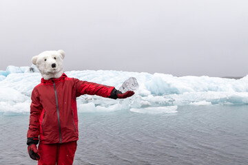 Activist on a polar bear mask holding a chunk of melting ice on Iceland's glaciers as a symbol of...