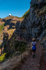A young woman on the trail to the Ninho da Manta viewpoint on Pico do Arieiro, Madeira. Portugal