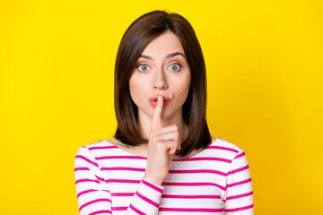 Closeup photo of young attractive funny girl keeping secret isolated on yellow color background