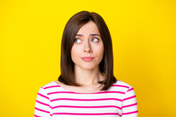 Fototapeta premium Closeup photo of young funny sad grimace girl looking empty space bad news isolated on yellow color background