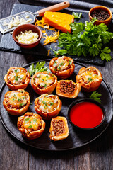 sloppy joe cups on black plate, top view