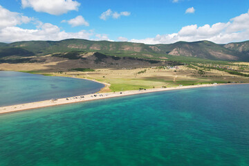 Lake Baikal from the air in summer. Beautiful turquoise color of water, mountains. View of the Kurminsky Bay. 