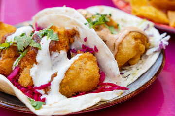 Mexican Fish Tacos Served with Red Cabbages on a Plate