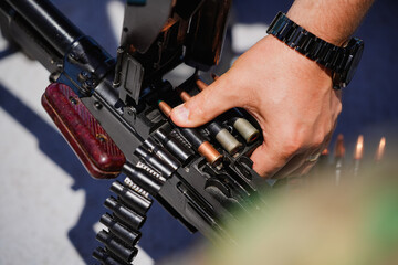 Machine gun belt loaded with cartridges - obrazy, fototapety, plakaty