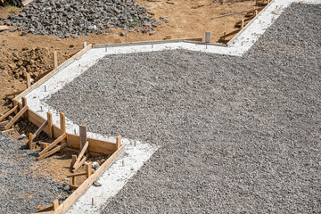 Concrete foundation of the house and backfilling of rubble.