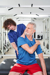 Physiotherapist doing healing treatment on man's shoulder