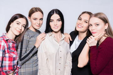 A portrait of pretty women on grey background.