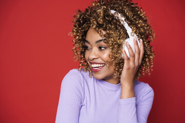 Young black woman with headphones smiling at camera