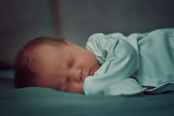 Sleeping newborn baby side view