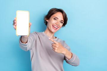 Photo of brown hairdo millennial lady index telephone wear grey sweatshirt isolated on blue color...