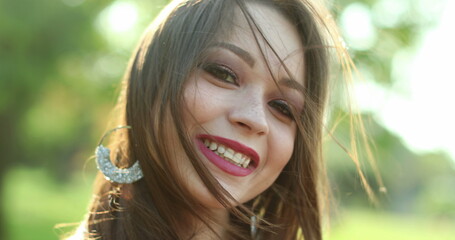 Happy joyful hispanic latina young millennial woman in 20s smiling in outdoor park