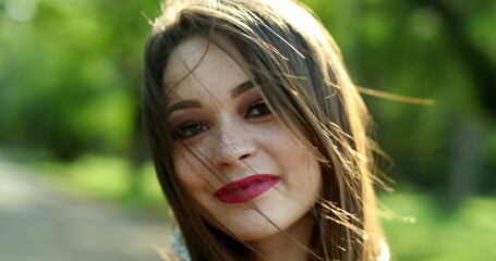 Happy joyful hispanic latina young millennial woman in 20s smiling in outdoor park
