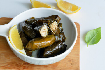 Grape leaf filled with rice served with lemon. Traditional Greek food