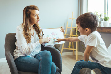 Boy listening to psychologist at meeting, thinking about her problems. A professional child...