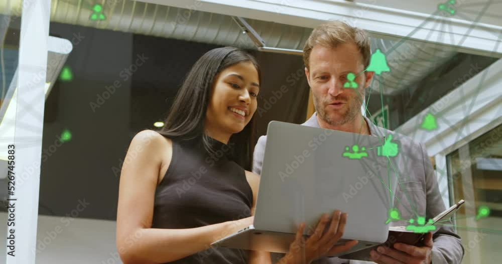 Aufkleber animation of connected computer icons forming globe over diverse coworkers analyzing data on laptop