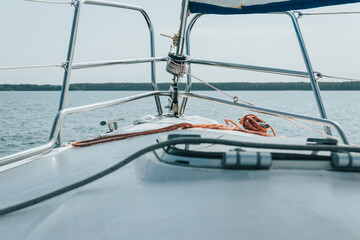 tackle on the bow of the yacht. the yacht is sailing on the lake.