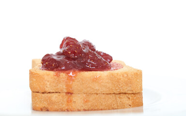 Homemade strawberry jam above sliced toast bread. Breakfast concept. Selective focus. Copy space...