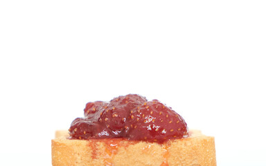 Homemade strawberry jam above sliced toast bread. Breakfast concept. Selective focus. Copy space area.