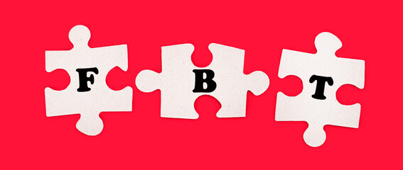 Three white jigsaw puzzles with the text FBT Fringe Benefit Tax on a bright red background.