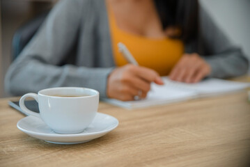 Planner plan Schedule Calendar and reminder agenda, work at home. Woman hand planning daily appointment and writing business trip in diary book at office desk. 2023 Calendar reminder event concept.